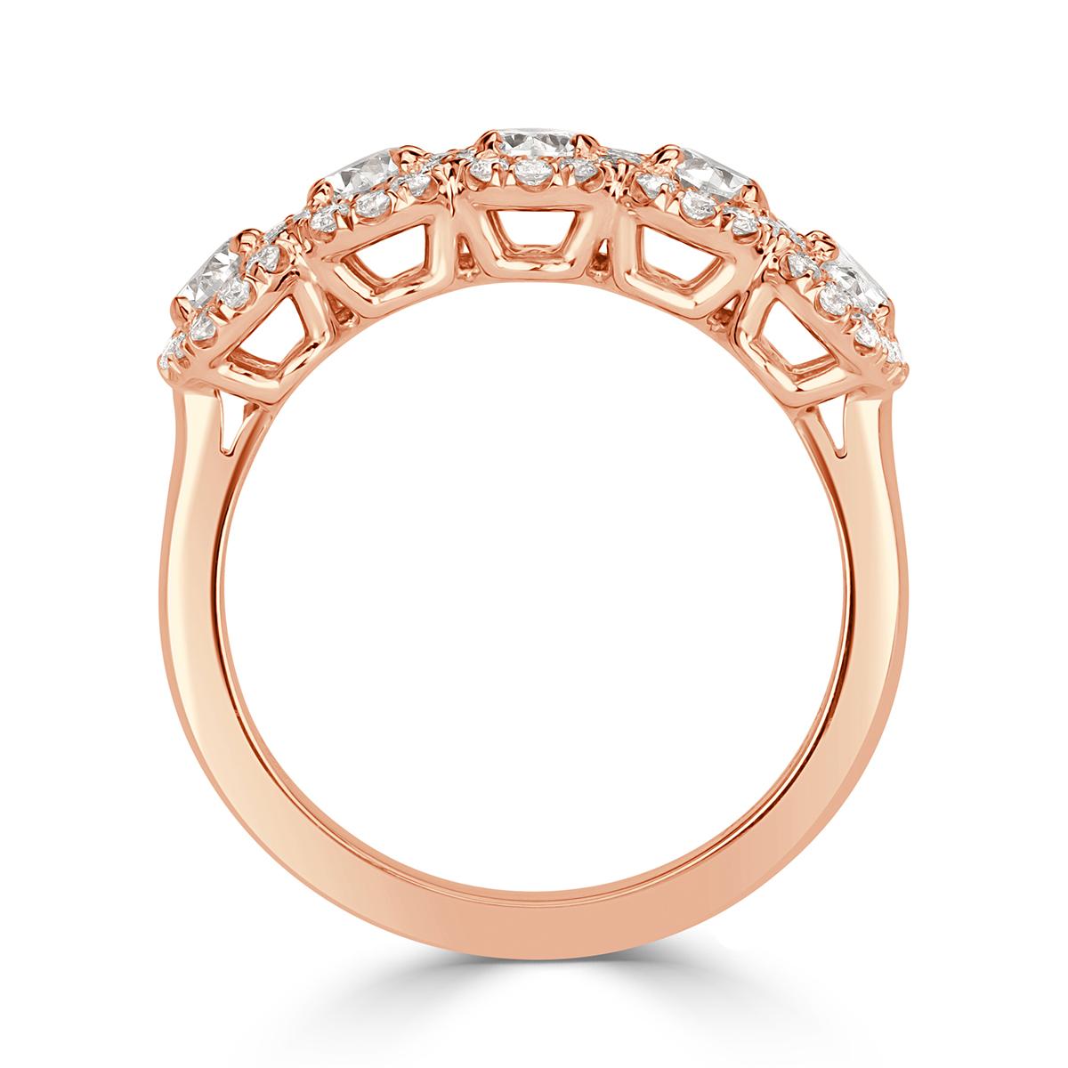 This elegant diamond ring showcases an exquisite five stone design composed of larger oval cut diamonds each surrounded by a halo of shimmering round brilliant cut diamonds. They are set in 18k rose gold and graded at E-F in color, VS1-VS2 in