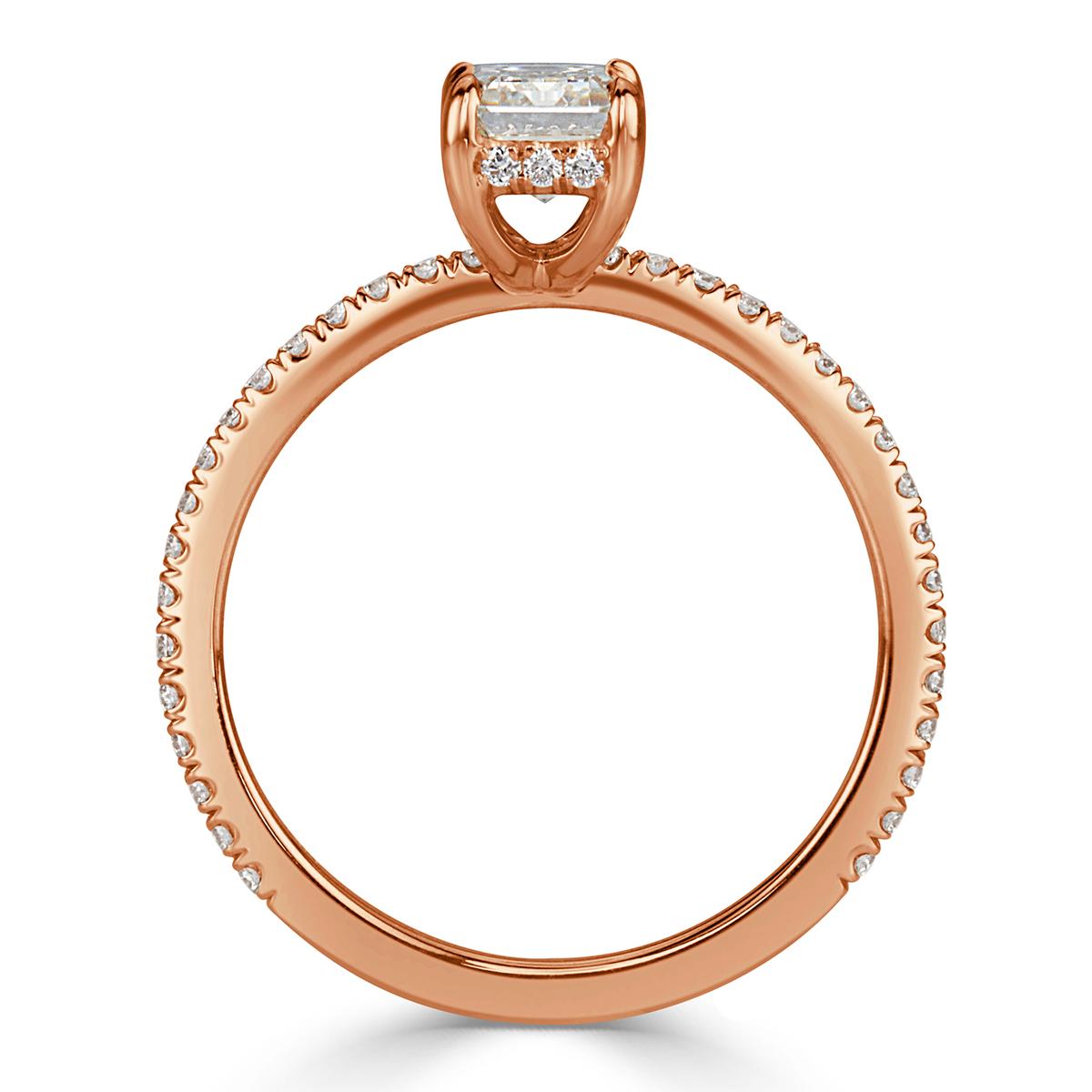 Created in 18k rose gold, this stunning diamond engagement ring features an elegant 1.01ct emerald cut center diamond, GIA certified at G-VS1. It is perfectly white and clear with amazing measurements of 6.79 x 4.57 mm. It is accented by a hidden