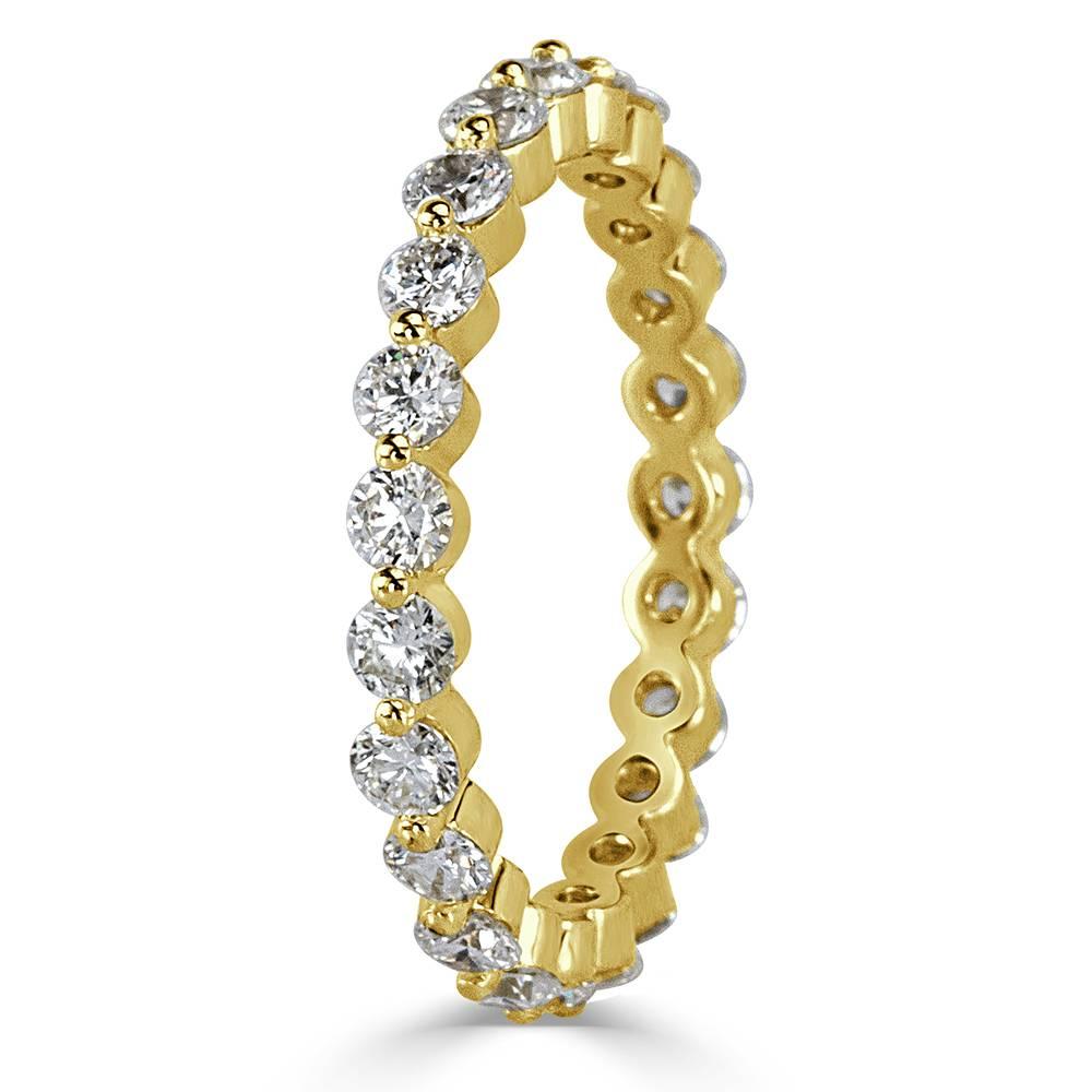 This beautiful diamond eternity band features 1.40ct of round brilliant cut diamonds individually prong set in 18 yellow gold. The diamonds are impeccably matched and graded at E-F in color, VS1-VS2 in clarity.