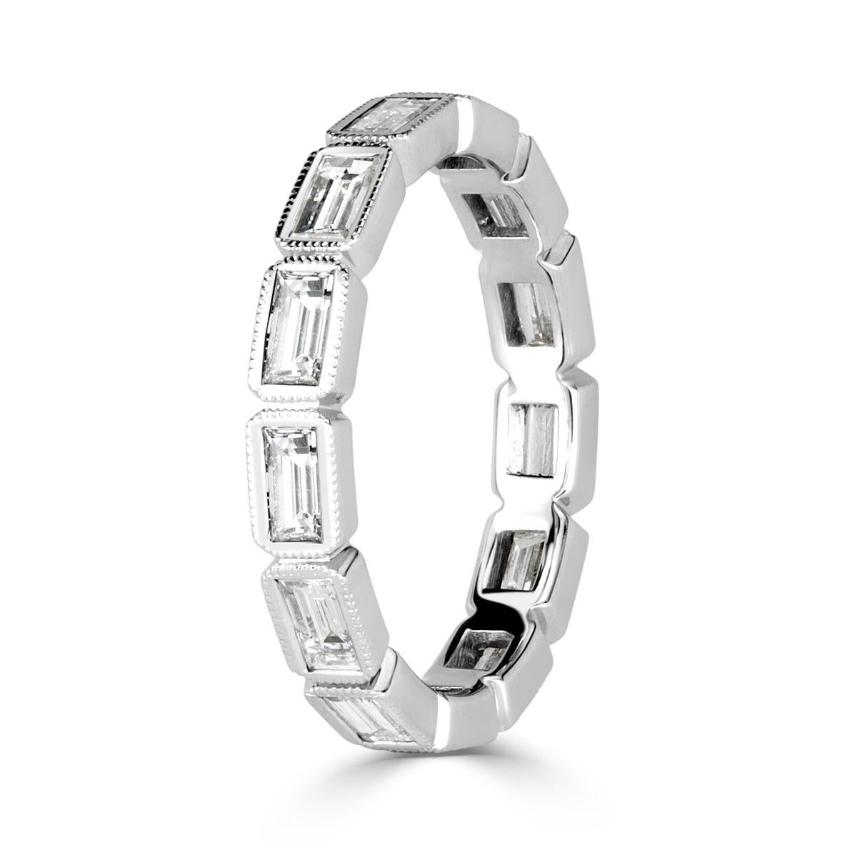 Custom created in 18k white gold, this one of a kind diamond eternity band showcases 1.40ct of impeccably matched baguette cut diamonds graded at E-F in color, VS1-VS2 in clarity. They are each complimented by exquisite milgrain detail throughout.