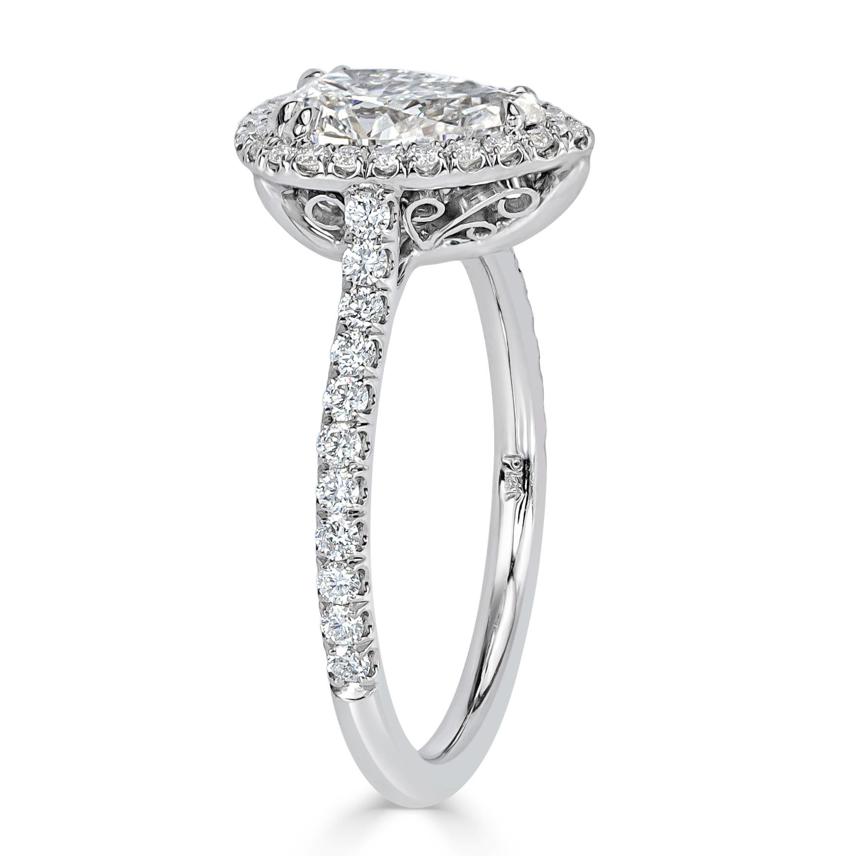 Created in platinum, this ravishing diamond engagement ring showcases an exquisite 1.03ct pear shaped center diamond, GIA certified at F-VS2. It is accented by a halo of round brilliant cut diamonds as well as one row of shimmering diamonds micro