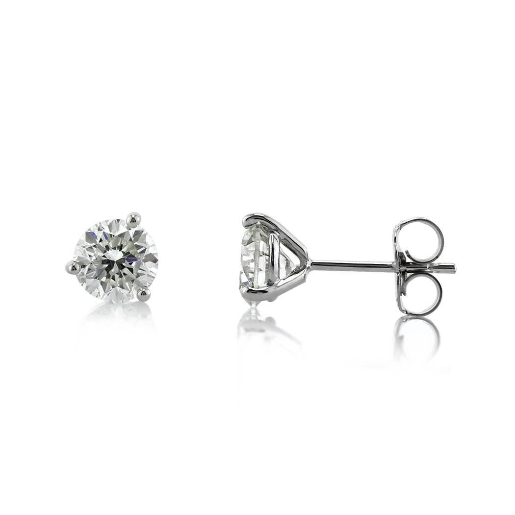 These gorgeous pair of diamond stud earrings showcases two round brilliant cut diamonds with a total weight of 1.43ct and EGL certified at G-VS2 and H-SI1. They are set in 14k white gold martini setting style posts with butterfly backs.