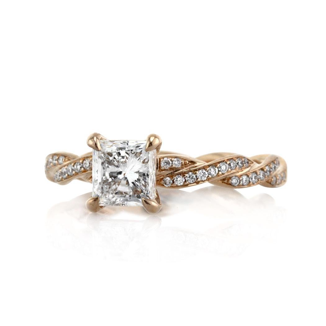 Custom created in 18k rose gold, this truly ravishing princess cut diamond engagement ring showcases a 1.04ct princess cut center diamond, GIA certified at F in color, VS2 in clarity. It is poised atop a unique twisted band micro pavé set with