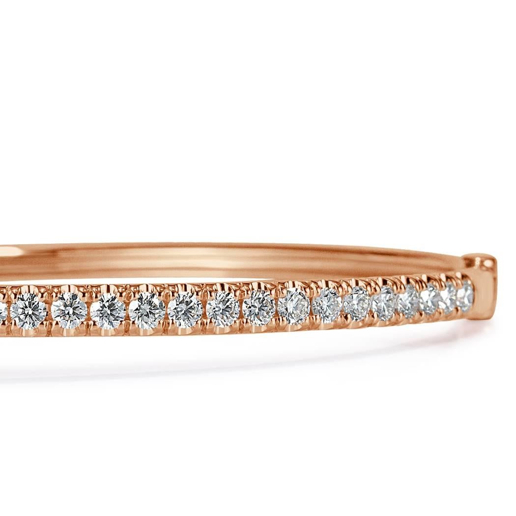 This striking modern bangle showcases 1.45ct of round brilliant cut diamonds hand set in 14k rose gold. The diamonds are beautifully matched and graded at E-F, VS1-VS2.