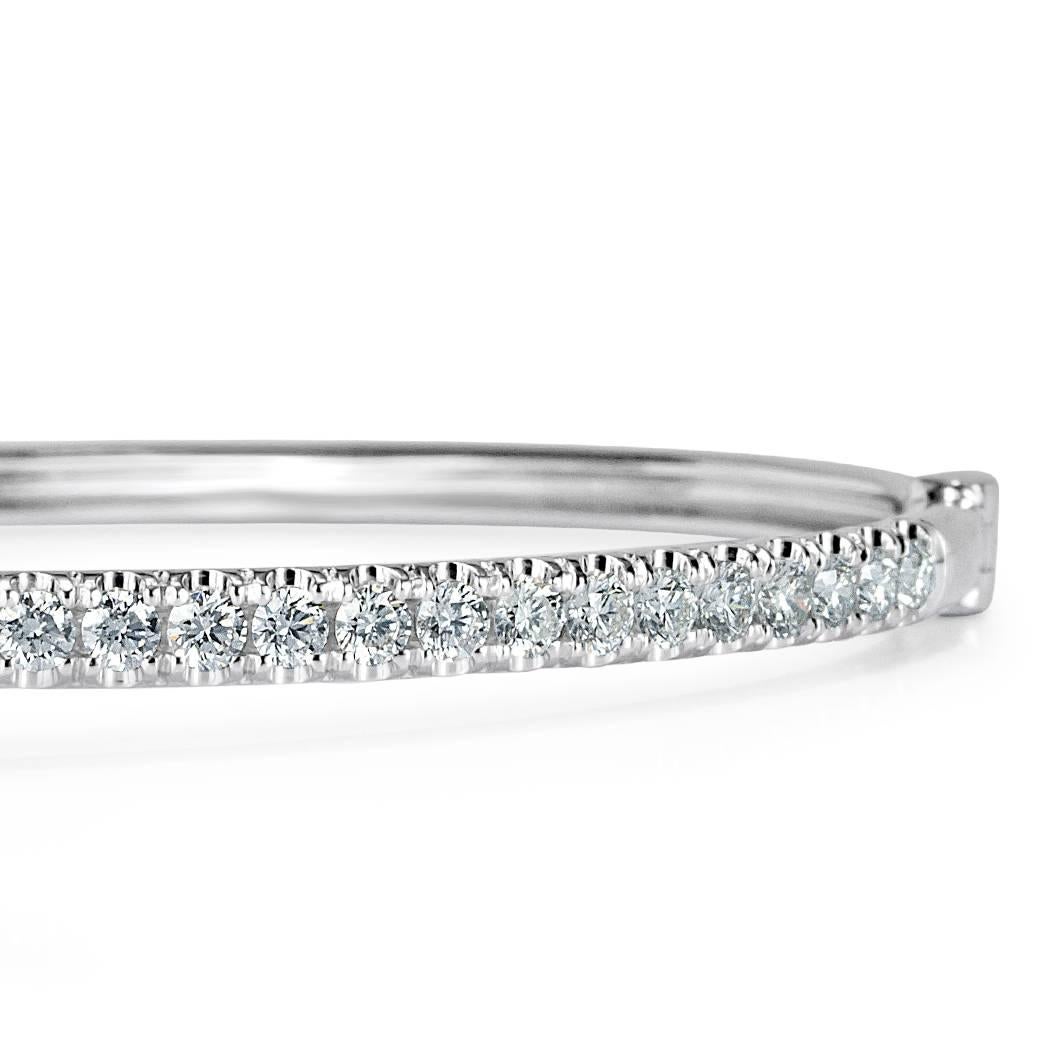 Created in 14k white gold, this modern and feminine diamond bangle is micro pavé set with 1.45ct of round brilliant cut diamonds hand set in 14k white gold. They are impeccably matched and graded at E-F, VS1-VS2.