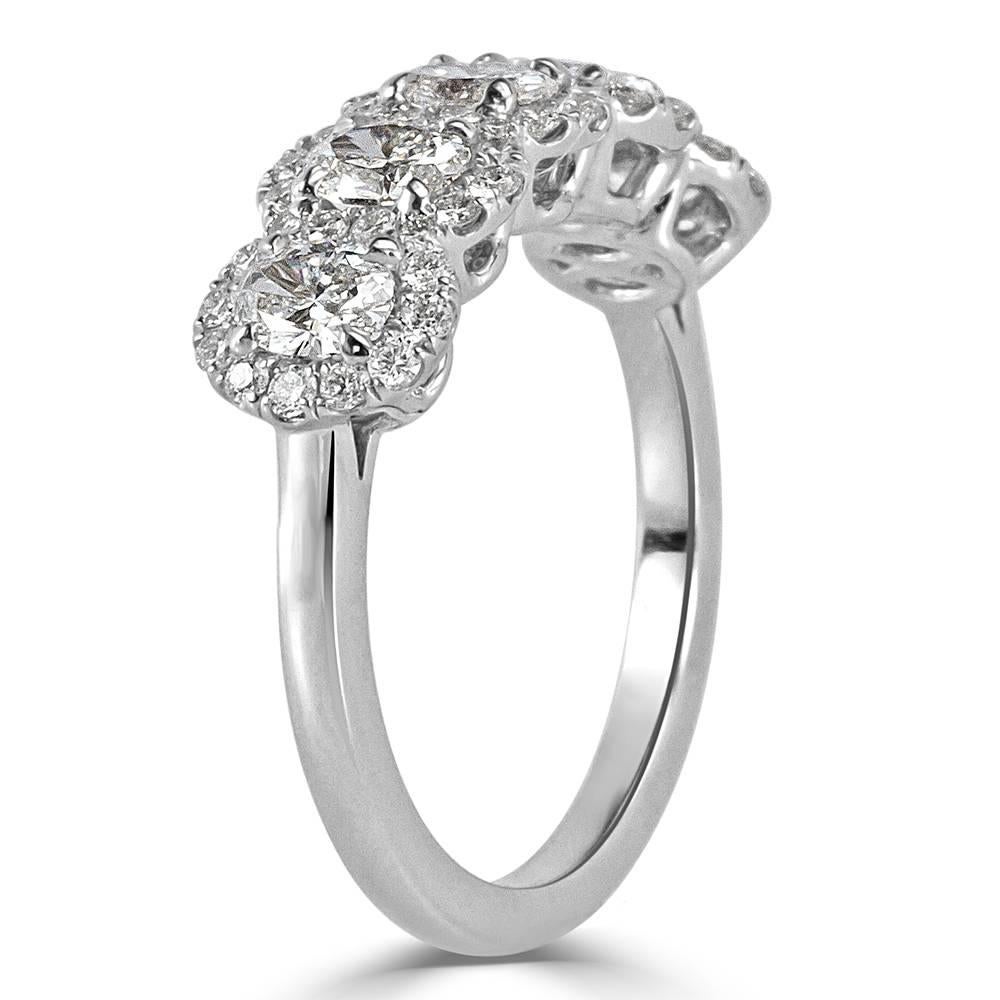 This five-stone ring showcases five gorgeous oval cut diamonds each surrounded by a halo of round brilliant cut diamonds. All of the diamonds total 1.50ct in weight and are graded at E-F, VS1-VS2.