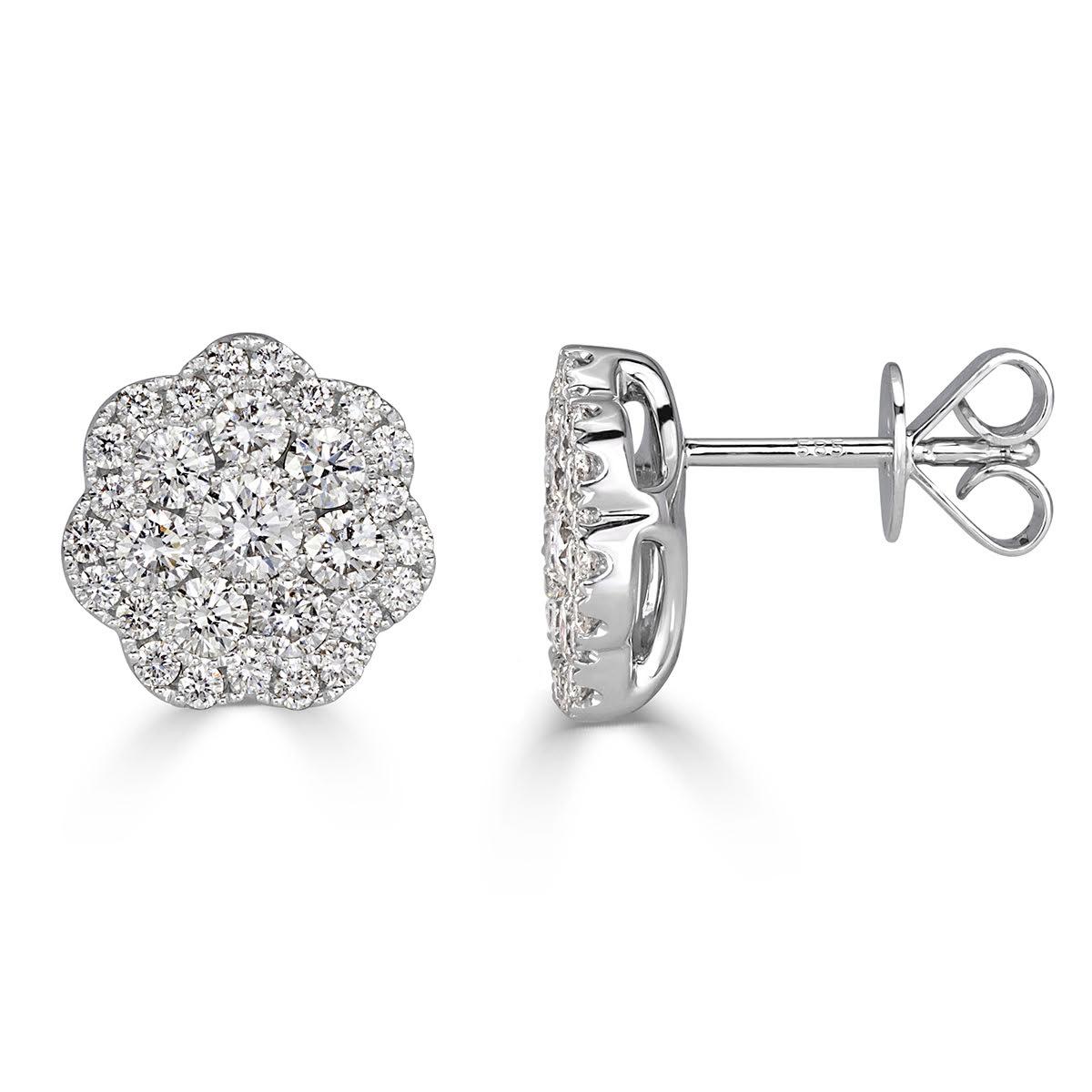 Absolutely stunning from every angle, this exquisite pair of diamond stud earrings showcases 1.50ct of round brilliant cut diamonds graded at E-F, VS1-VS2. The are set in a lovely, 14k white gold floral design. This stylish pair of earrings is truly
