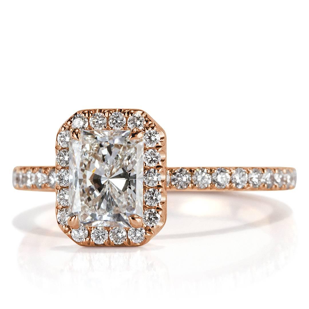 This gorgeous diamond engagement ring showcases a superb 1.02ct radiant cut center diamond, GIA certified at G-VS2. It is complimented by a shimmering halo of round brilliant cut diamonds as well as one row of diamonds micro pavé set around the