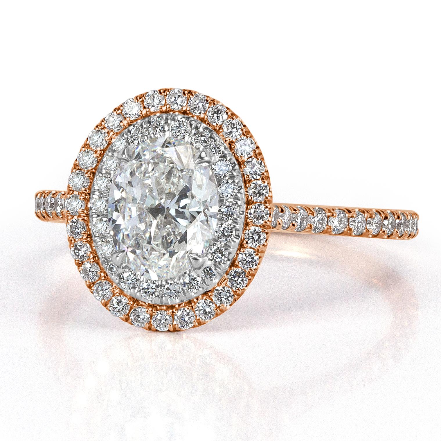 This two-tone diamond engagement ring features a ravishing 1.00ct oval cut center diamond, GIA certified at F-VS2. It is accented by a double halo of round brilliant cut diamonds as well as one row of shimmering diamonds micro pavé set around the