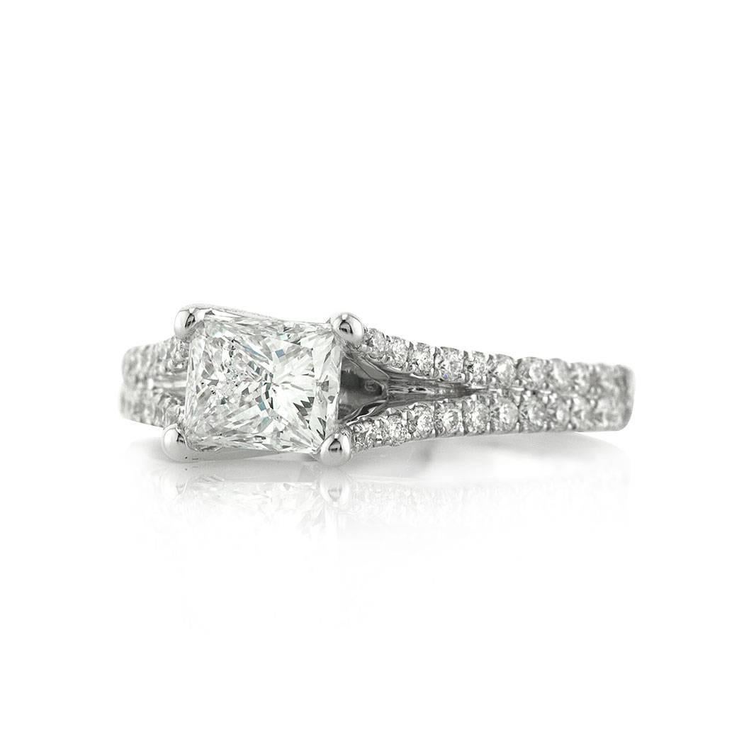 This beautiful diamond engagement ring features a superb 1.07ct princess cut center diamond, AGS certified at G-SI2. It is beautifully set East to West for a unique look and accented by 0.50ct of round brilliant cut diamonds micro pavé set around