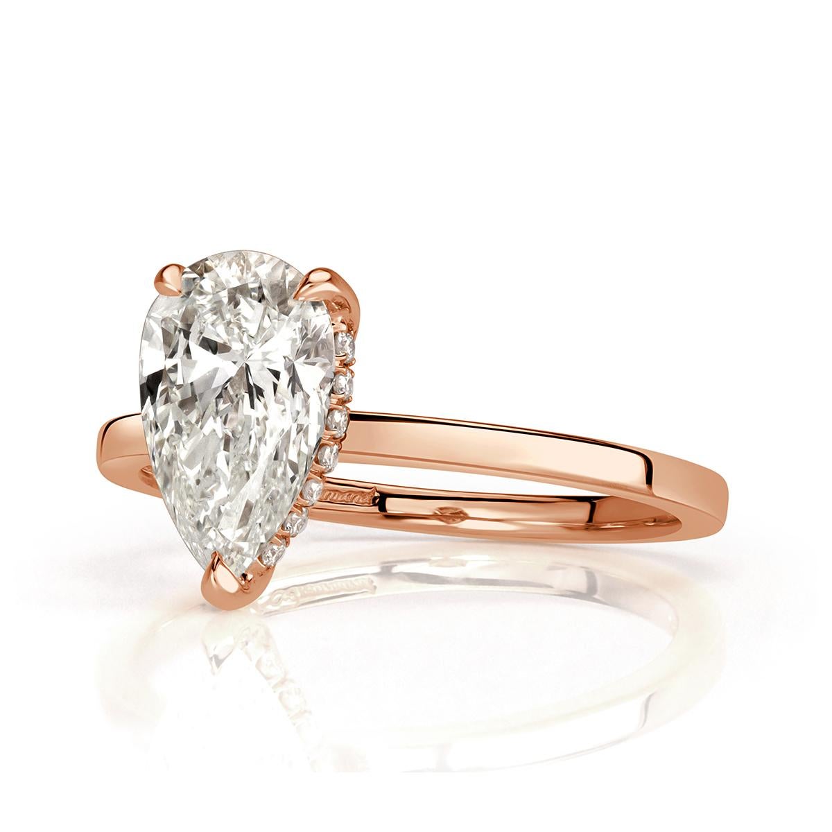 Created in our custom 18k rose gold solitaire setting style, this one of a kind diamond engagement ring features a gorgeous 1.50ct pear shaped center diamond, GIA certified at J in color, VS2 in clarity. It is accented by a hidden halo of round