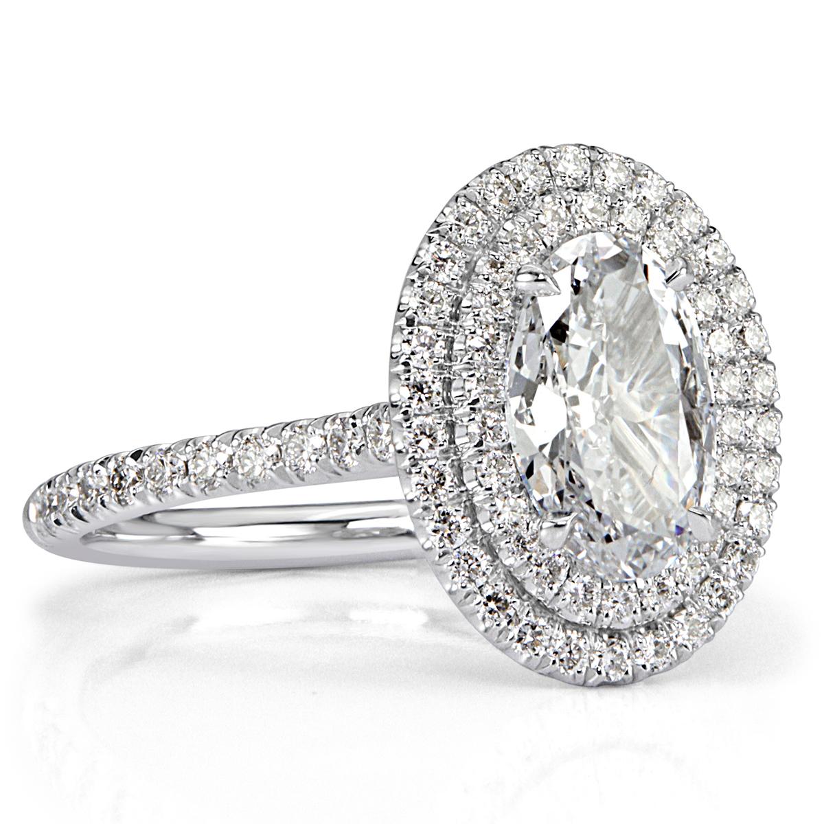 This beautiful oval cut diamond engagement ring features a 1.01ct oval cut center diamond, GIA certified at E-SI1. It is surrounded by a gorgeous double halo of round brilliant cut diamonds as well as dazzling diamonds micro pavé set down the