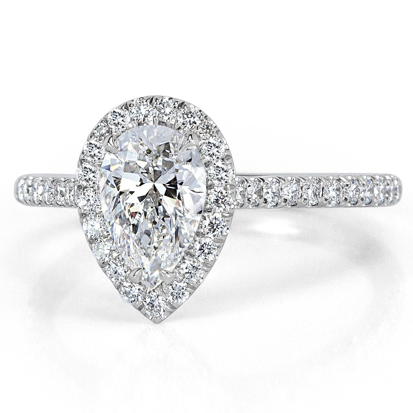 Created in our custom micro pavé setting style, this ravishing diamond engagement ring showcases a gorgeous 1.00ct pear shaped center diamond, GIA certified at E in color, VS2 in clarity. It faces up incredibly white and sparkles with tremendous