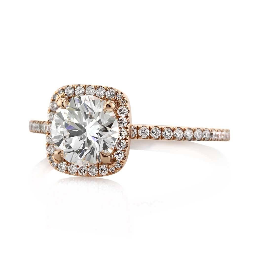 This diamond engagement ring features a 1.23ct round brilliant cut diamond GIA certified at G, VS2 and set on 18k rose gold. It is accented by micro pave diamonds in a cushion shaped halo around it and going down the shank just past half way.