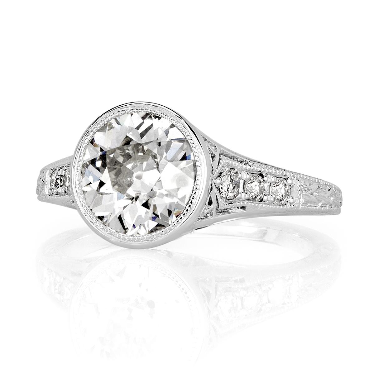 This gorgeous estate diamond  ring showcases a very rare old European cut center diamond, GIA certified at L-VS2. It is bezel set in a unique center basket accented with hand milgrain detail and embellished with heart shaped filigree design on the