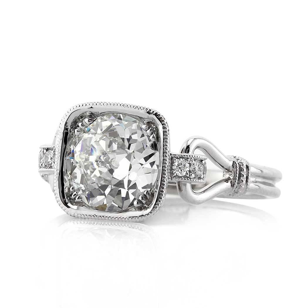 This gorgeous diamond engagement ring showcases a 1.60ct old European cut center diamond, GIA certified at I-VVS2. It is set in a custom created setting featuring a very unique platinum band stemming from the cushion shaped center basket. The top