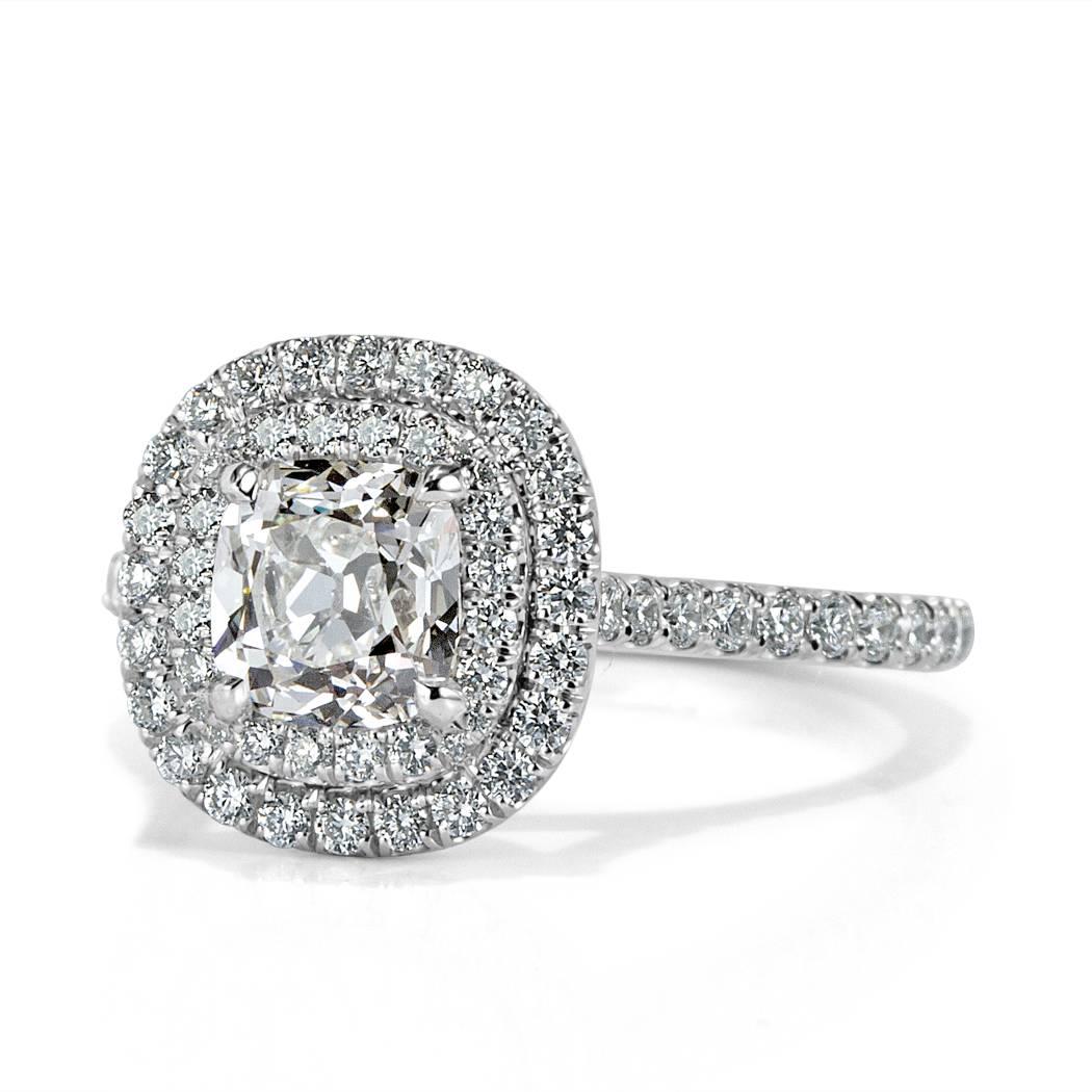This unique diamond engagement ring is set with a 1.03ct old Mine center diamond, GIA certified at H-VS1. It is encased in a double halo of round brilliant cut diamonds with micro pavé diamonds set around the dainty platinum shank. The accent