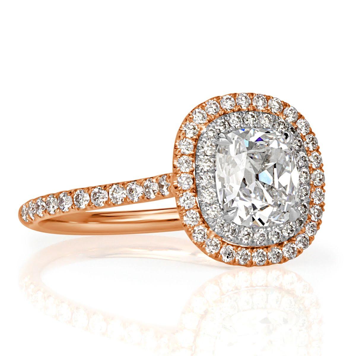 This mesmerizing diamond engagement ring features a beautiful 1.20ct old Mine cut center diamond, GIA certified at H in color, SI1 in clarity. It is encased in a double halo of round brilliant cut diamonds and accented by gleaming diamonds set on