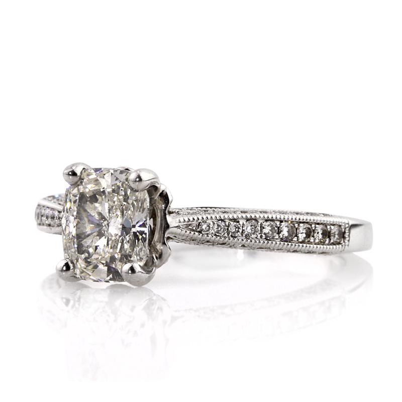 This ravishing diamond engagement ring features a 1.22ct cushion cut center diamond, EGL certified at G-SI1. It is set in an exquisite 18k white gold setting featuring pavé diamonds studded on the center basket and on all three sides of the band.