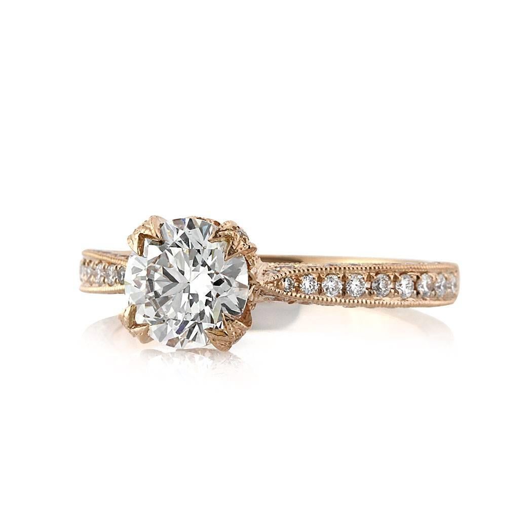 Custom created in 18k rose gold, this ravishing diamond engagement ring features a gorgeous 1.25ct round brilliant cut center diamond, GIA certified at H-VS1. The beautifully handcrafted center prongs showcase it perfectly with shimmering diamonds