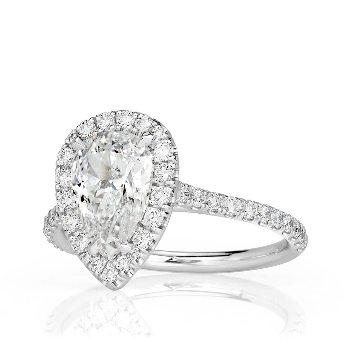 Created in platinum, this mesmerizing diamond engagement ring showcases a 1.52ct pear shaped center diamond, GIA certified at E-SI1. It is accented by a shimmering halo of round brilliant cut diamonds as well as one row of sparkling diamonds micro