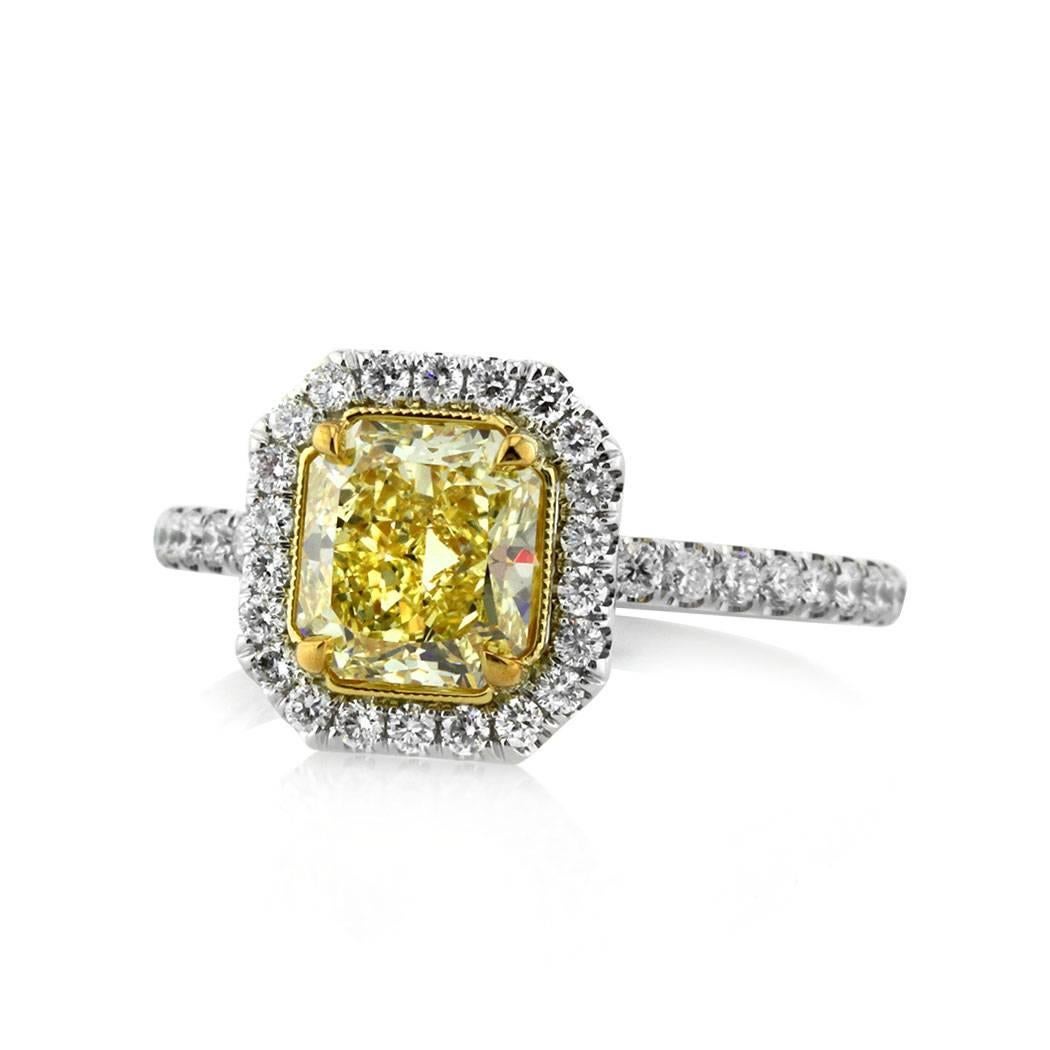 This fancy yellow diamond engagement ring features a stunning 1.36ct radiant cut center diamond, GIA certified at Fancy Intense Yellow-VS1. It is accented by a halo of peerless white round brilliant cut diamonds as well as sparkling diamonds micro