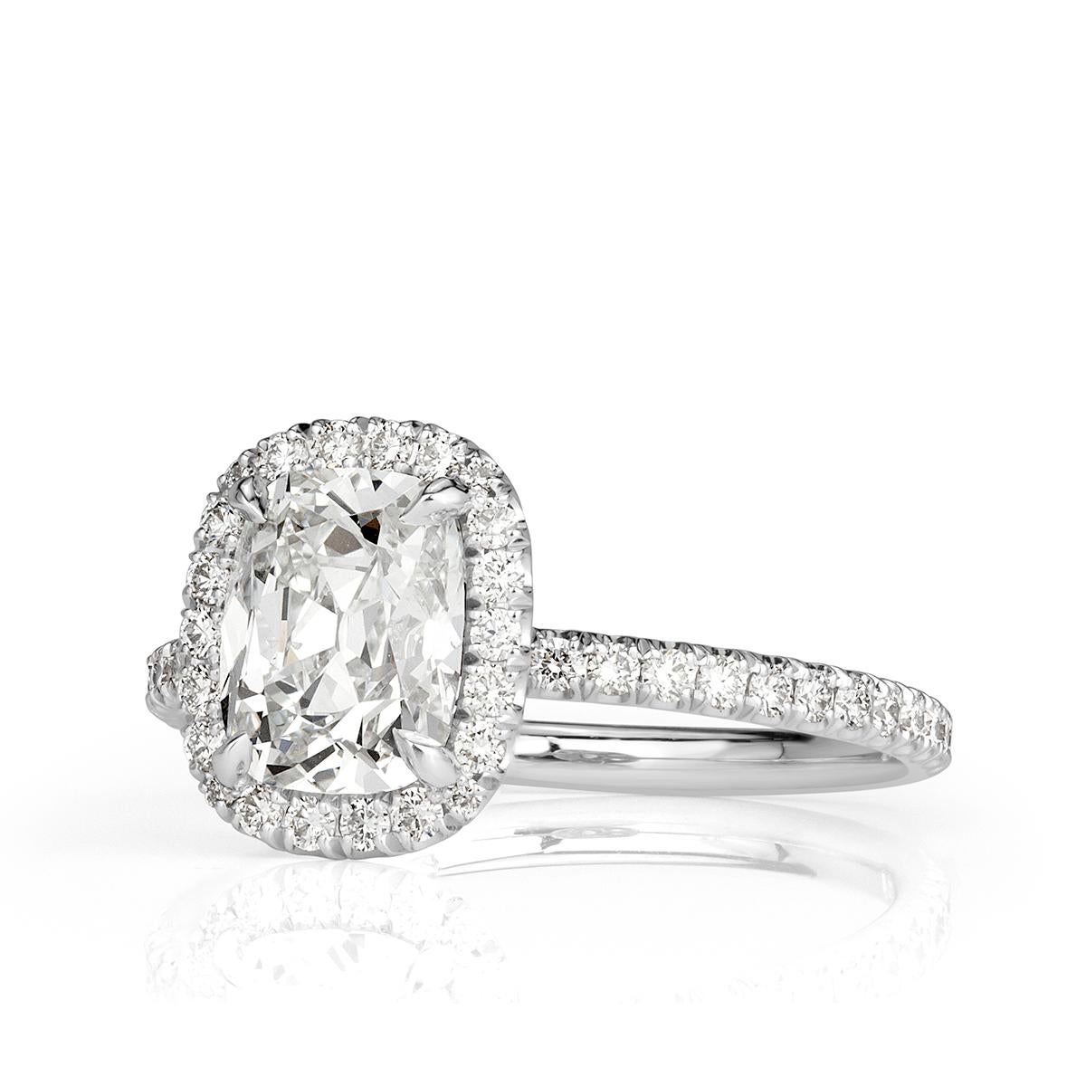 Exquisitely handcrafted in platinum, this ravishing diamond engagement ring showcases a unique 1.59ct old Mine cut center diamond, GIA certified at G-SI1. It measures 7.77 x 6.21 mm, an extremely rare proportion and cut. It is complimented by a