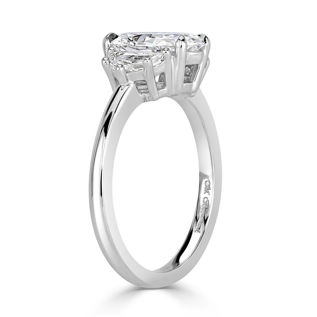 This unique, three-stone oval cut diamond engagement ring features a gorgeous 1.61ct oval cut center diamond, GIA certified at D-VVS2. It has amazing measurements of 10.47 x 6.49 mm which means it is very elongated and looks much larger than its
