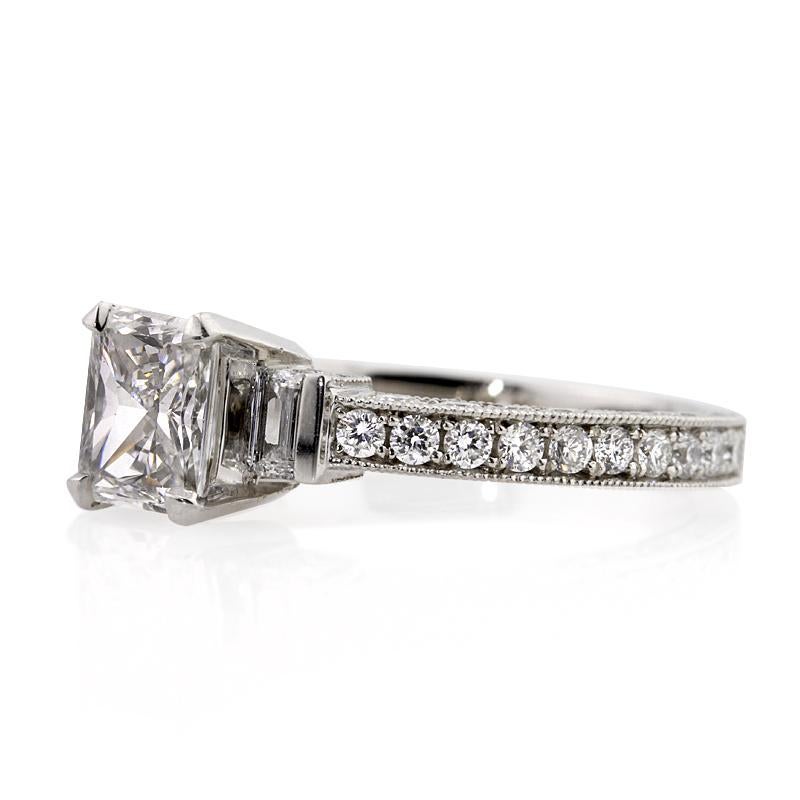 Custom created in platinum, this beautiful diamond engagement ring features a lovely 0.92ct radiant cut center diamond, GIA certified at F in color, VS2 in clarity. It is set atop a dainty micro pavé shank and accented by two baguette cut diamonds