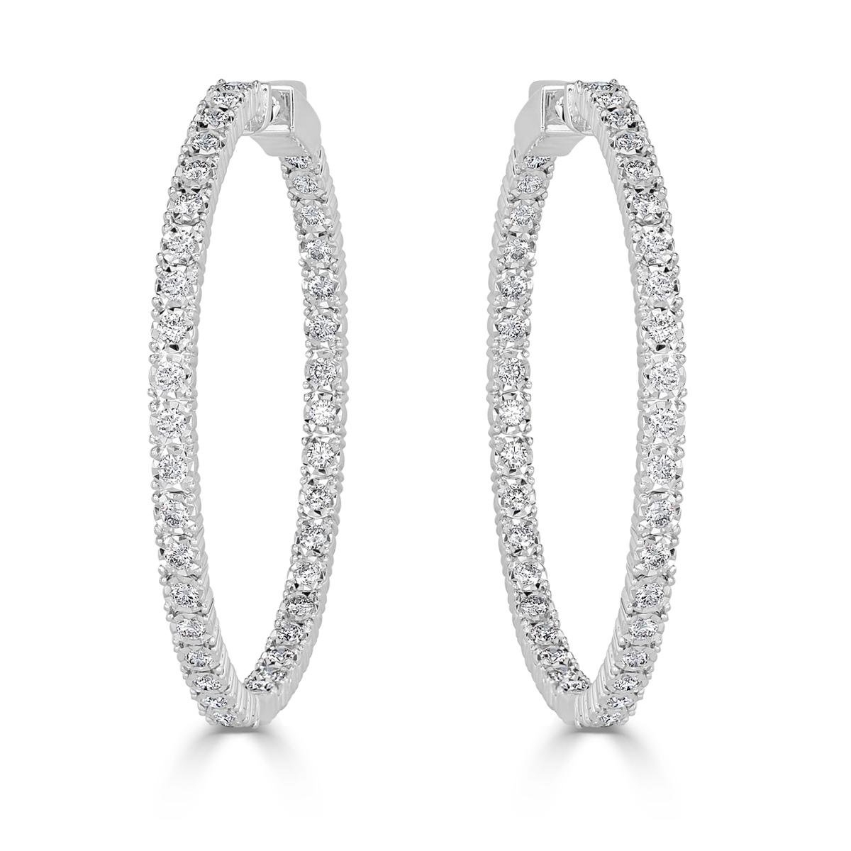 Custom created in 14k white gold, this gorgeous pair of round brilliant cut diamond hoop earrings showcases a total of 2.37ct of shimmering round brilliant cut diamonds set in a classic 4 prongs setting style. The diamonds are graded at E-F in color