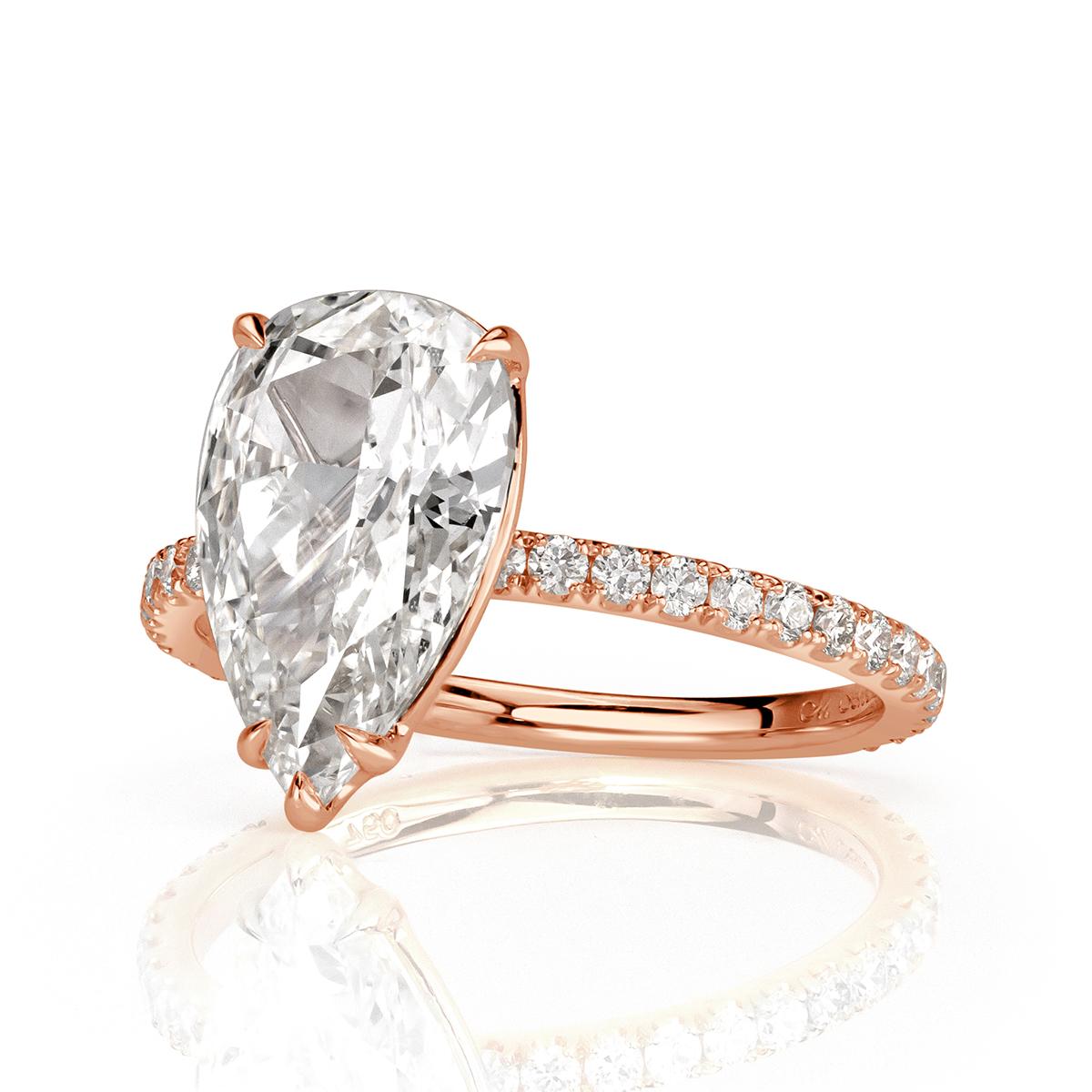 Custom created in 18k rose gold, this stunning diamond engagement ring showcases a gorgeous 2.03ct pear shaped center diamond, GIA certified at I-SI1. It faces up white and is perfectly eye clean in addition of measuring an incredible 12.14 x 7.43mm