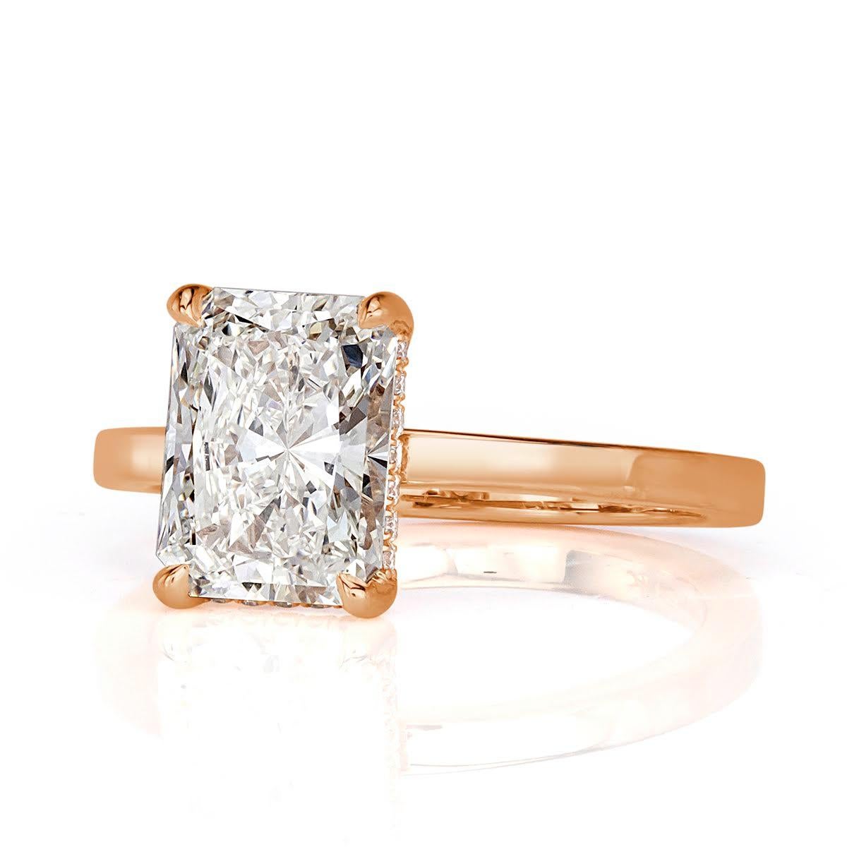 Custom created in our custom 18k rose gold, this one of a kind diamond engagement ring showcases a stunning 2.30ct radiant cut center diamond, GIA certified at I in color, VVS2 in clarity. This hand picked diamond is graded at excellence in polish