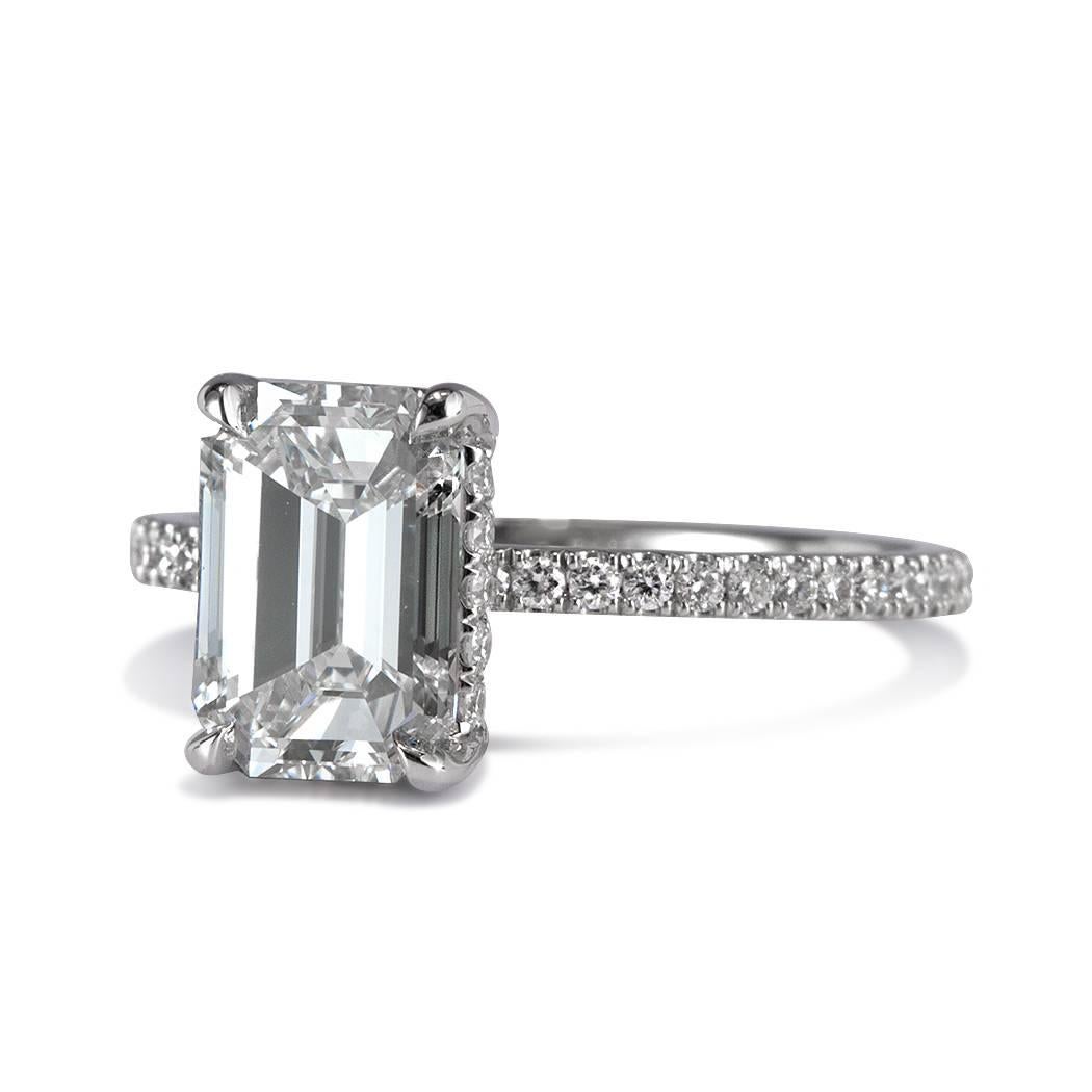 This elegant diamond engagement ring is set with a gorgeous 2.01ct emerald cut center diamond, GIA certified at H-VS2. It is accented by 0.40ct of round brilliant cut diamonds studded on the center basket and micro pavé set around the dainty