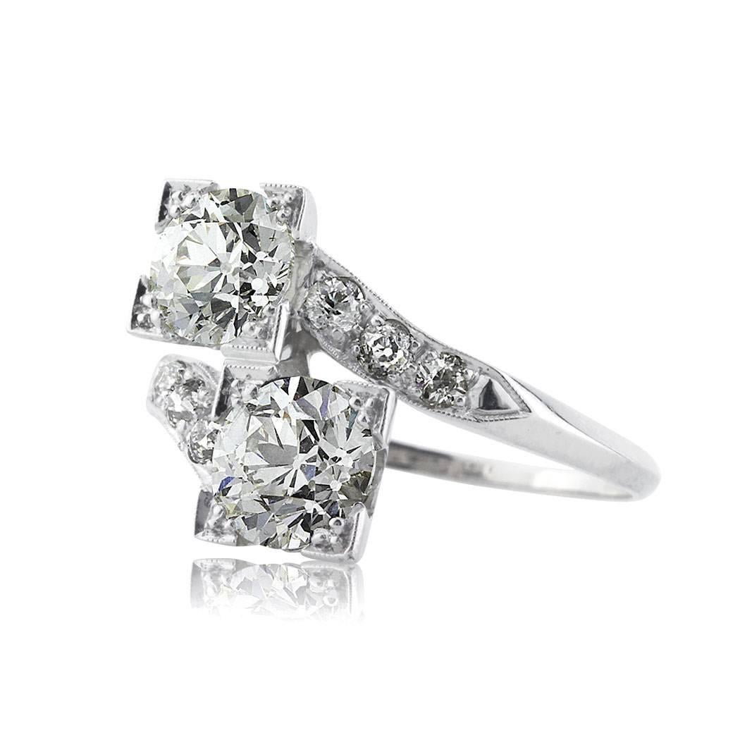 This one of a kind diamond engagement ring is set with two old European cut center diamonds with a total weight of 2.28ct. They are beautifully matched and each GIA certified at K-VS2 and J-SI1. They are poised atop a very unique platinum band