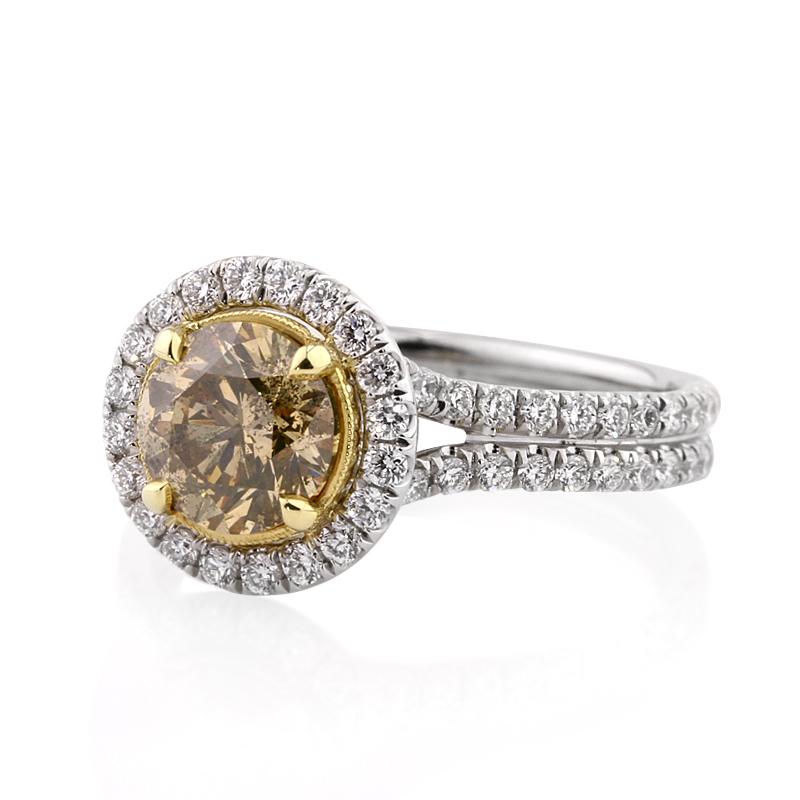 This unique fancy colored diamond engagement ring showcases a beautiful 1.39ct round brilliant cut center diamond, GIA certified at Fancy Brown Green Yellow-I1. It is accented by a matching halo of white round brilliant cut diamonds as well as micro