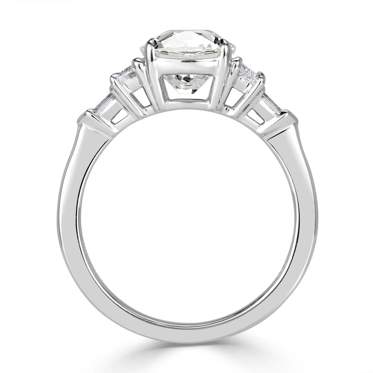 This stunning diamond engagement ring showcases a gorgeous 2.00ct old Mine cut center diamond, GIA certified at G-VS2. It is hand set in high polish 18k white gold and accented by two trapezoid and bullet cut diamonds on either side. The accent