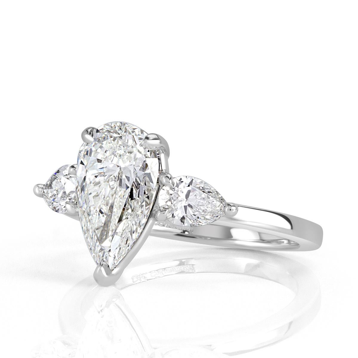 This superb diamond engagement ring showcases a gorgeous three-stone design of pear shaped diamonds with the stunning 2.02ct center diamond being GIA certified at G-SI1. It is peerless white and perfectly eye clean with amazing measurements of 11.56