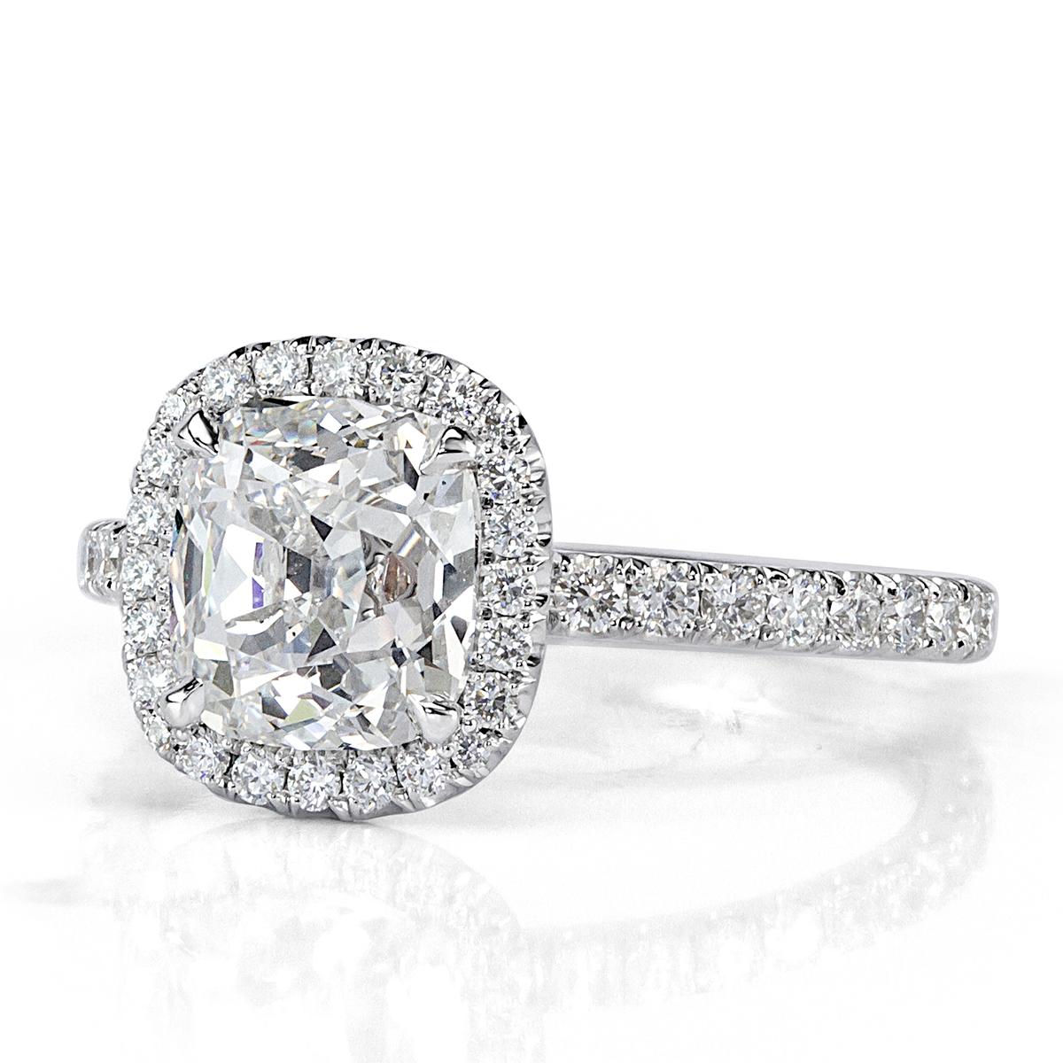 This stunning diamond engagement ring features a gorgeous 2.02ct old Mine cut center diamond, GIA certified at D-VS2. It is beautifully accented by a halo of round brilliant cut diamonds as well as sparkling diamonds adorning the connectors and the