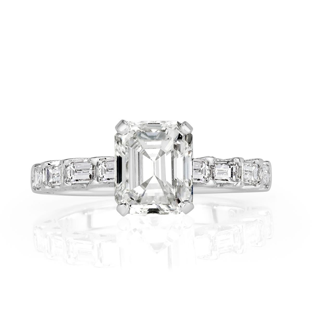 This captivating diamond engagement ring showcases a gorgeous 2.00ct emerald cut center diamond, EGL certified at G in color, VS1 in clarity. It is beautifully poised atop a unique 18k white gold shank graced by one row of baguette cut diamonds. The