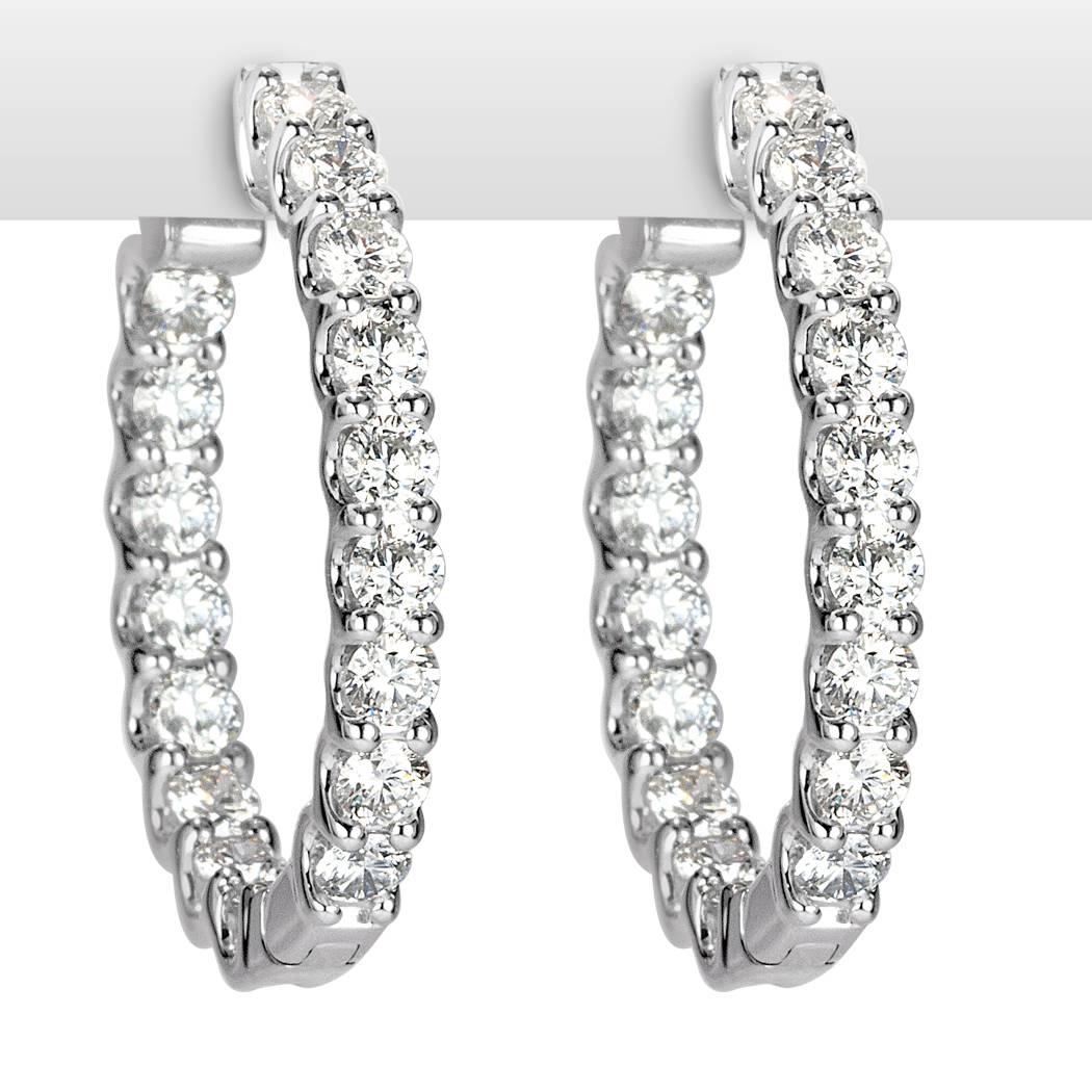 These stunning pair of diamond hoop earrings showcases 2.80ct of round brilliant cut diamonds graded at E-F in color, VS1-VS2 in clarity. They are each hand selected and set in 14k white gold.