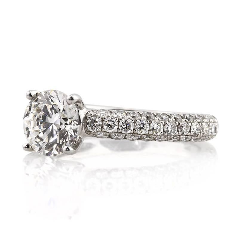This gorgeous diamond engagement ring features a superb 1.51ct round brilliant cut center diamond, GIA certified at F-VS2. It is accented by three rows of micro pavé diamonds seamlessly set on the unique, 18k white gold shank. The accent diamonds