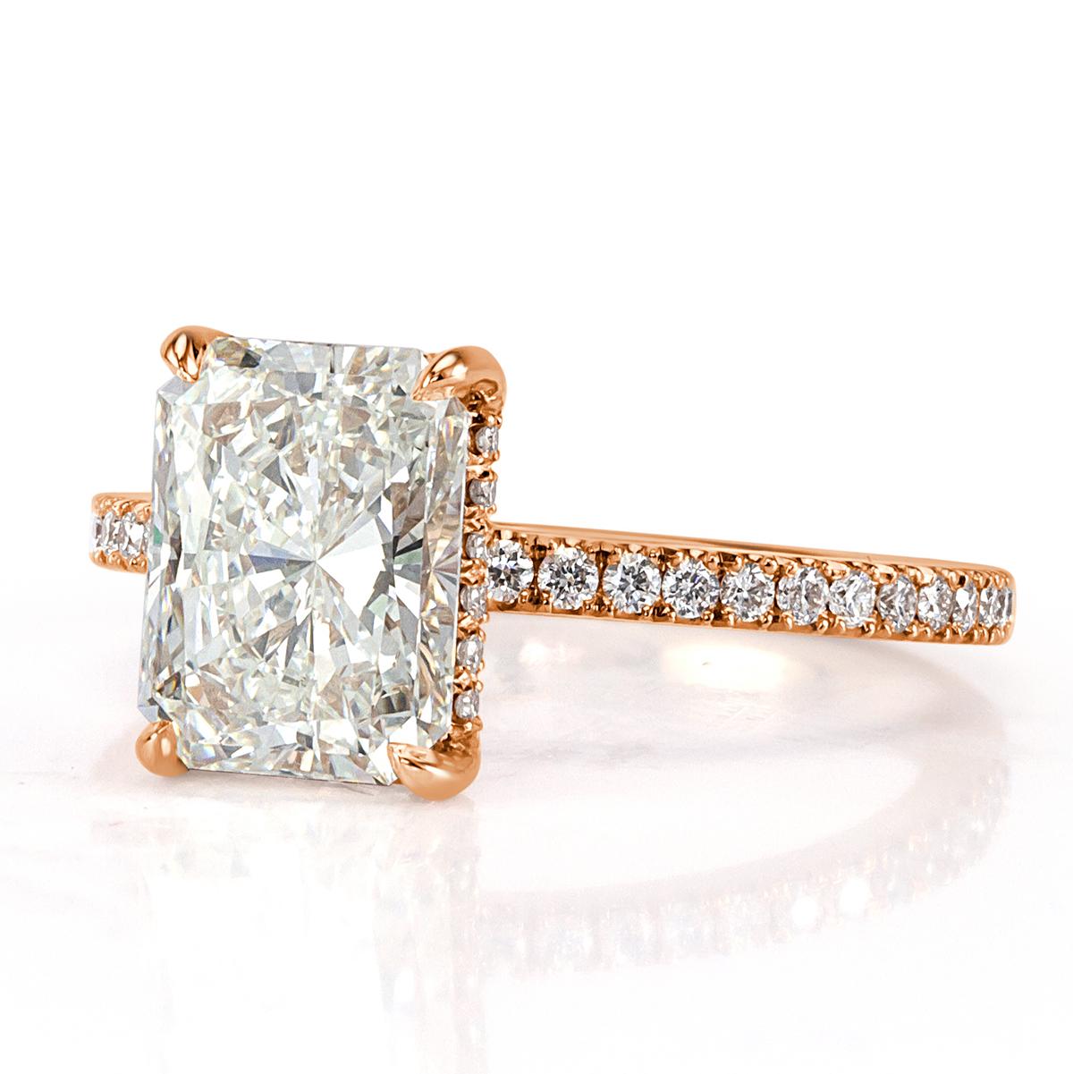 Handcrafted in 18k rose gold, this delightful diamond engagement ring showcases a gorgeous 2.50ct radiant cut center diamond, GIA certified at I-IF. It has amazing measurements of 9.07 x 6.97mm which allow this two and a half center piece to look