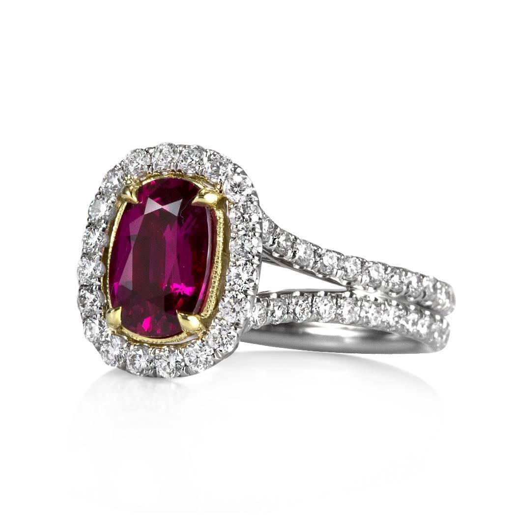 This stunning ruby and diamond engagement ring is truly one of a kind! It showcases a splendid 1.66ct cushion cut center ruby, GIA certified at purplish-red, non-heated. It is set in a yellow gold center basket contrasting perfectly with the