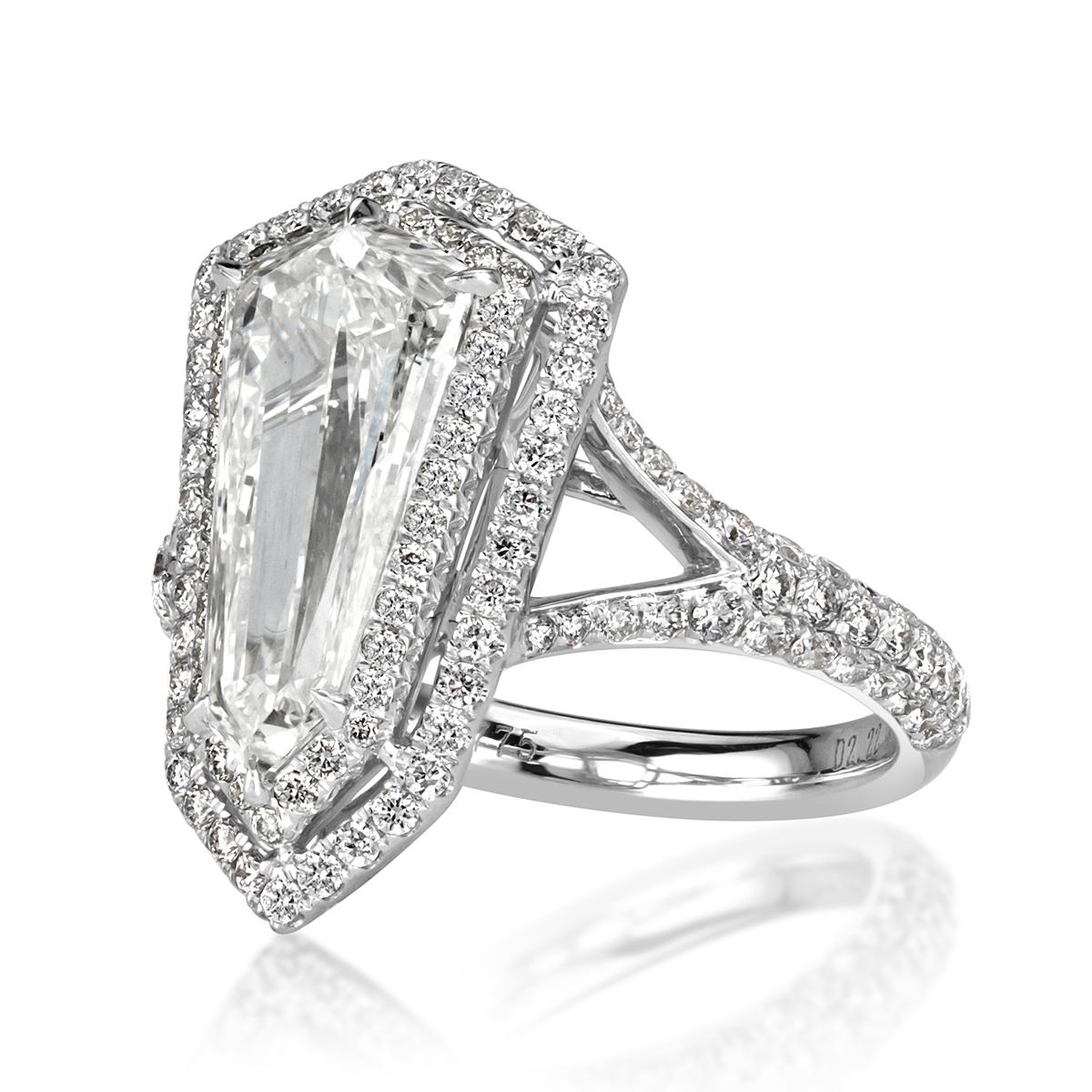 This unique diamond ring showcases a one-of-a-kind 2.22ct shield cut center diamond, measuring at 13x6.5mm, complimented by a gleaming double halo of round brilliant cut diamonds. For added sparkle, the dainty split shank is also studded with two