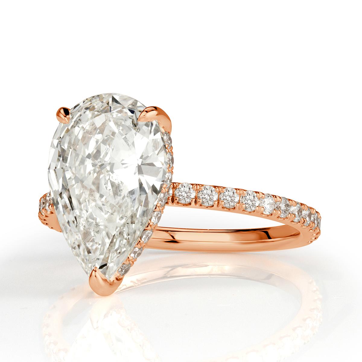 Custom created in 18k rose gold, this gorgeous diamond engagement ring features a stunning 3.01ct pear shaped center diamond, GIA certified at J in color, VS2 in clarity. It faces up white and is immensely brilliant in addition of having exceptional