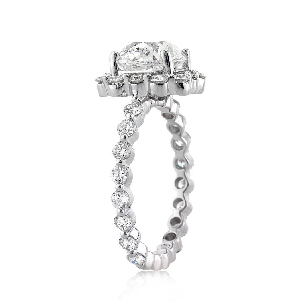 This superb antique cut diamond engagement ring features a unique 2.40ct old Mine cut center diamond, GIA certified at F-SI1. It is surrounded by round brilliant cut diamonds set in a very unique setting style with hardly any metal showing. The 18k
