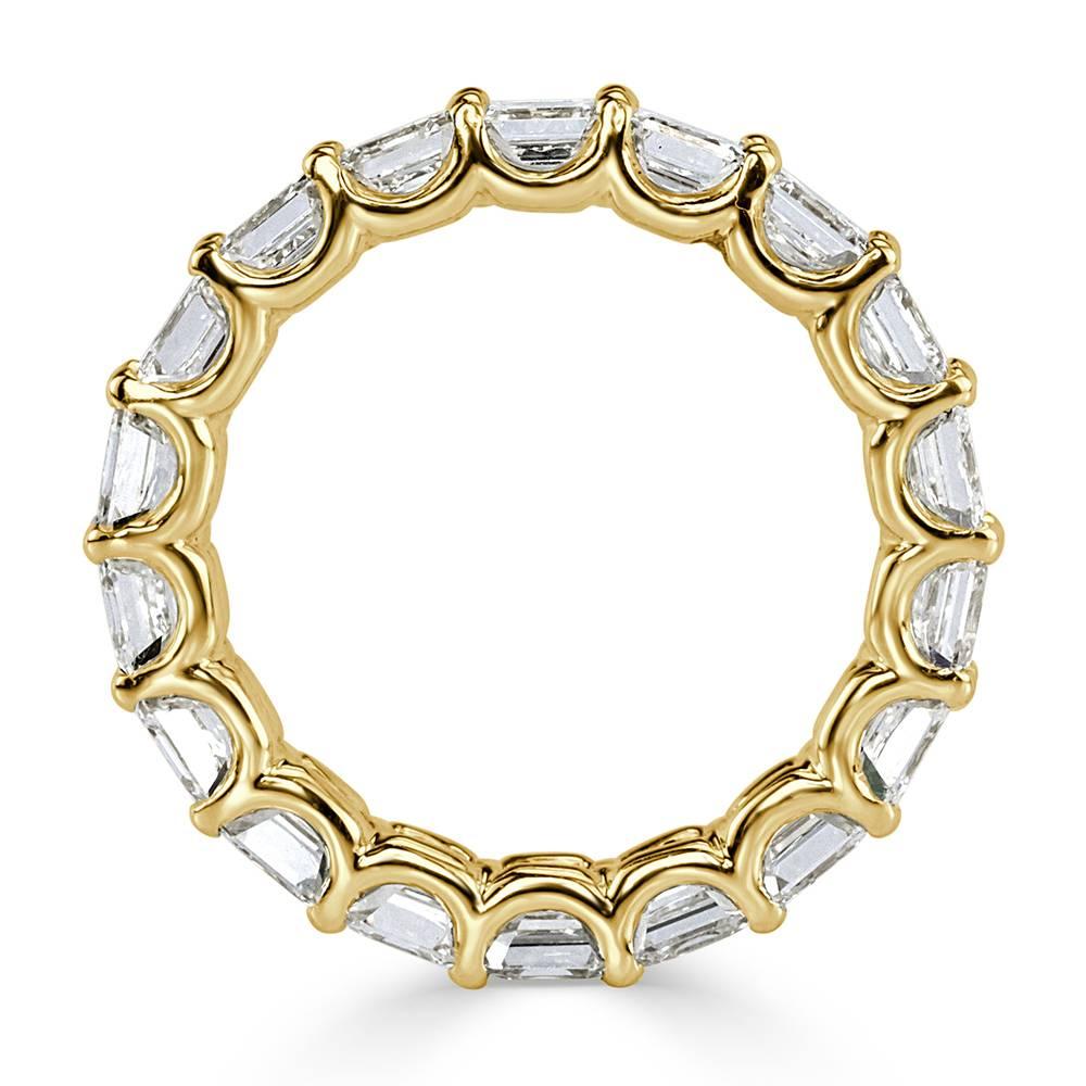 This stunning diamond eternity band features 3.85ct of Asscher cut diamonds graded at G-H, VS1-VS2. They are beautifully showcased in an 18k yellow gold shared prong setting throughout. All eternity bands are shown in a size 6.5. We custom craft