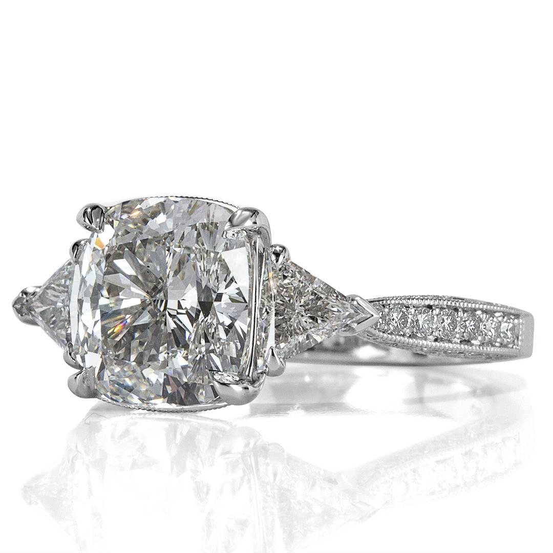 This stunning diamond engagement ring showcases a superb 3.00ct cushion cut center diamond GIA certified at H, VS2. It is accented by two triangle cut diamonds on the sides as well as sparkling round brilliant cut diamonds going down the platinum
