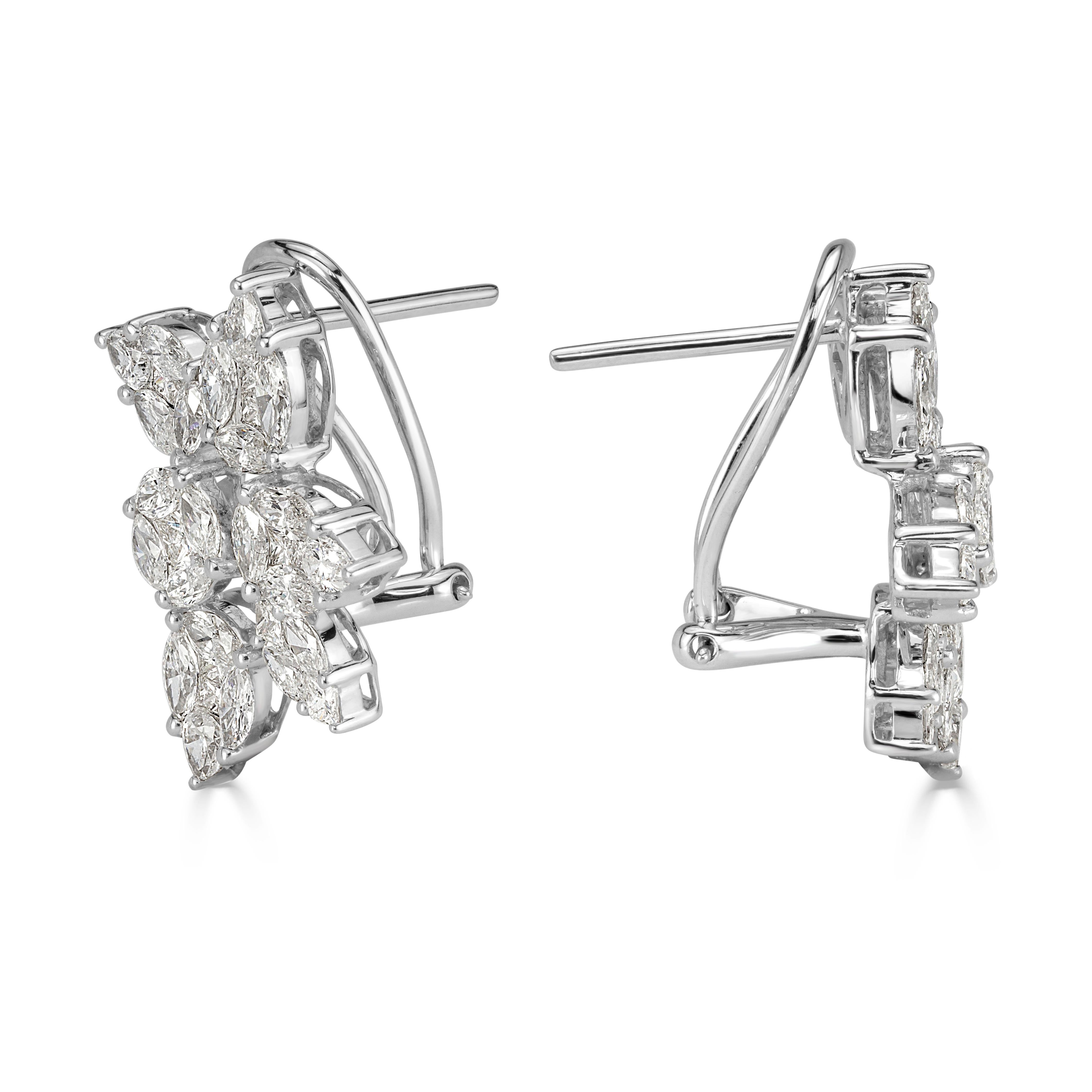 This truly elegant and stylish pair of diamond cluster earrings showcases an exquisite floral design of marquise, princess cut and pear shaped diamonds set in 18k white gold. The diamonds are graded at G-H in color, VS1-VS2 in clarity.