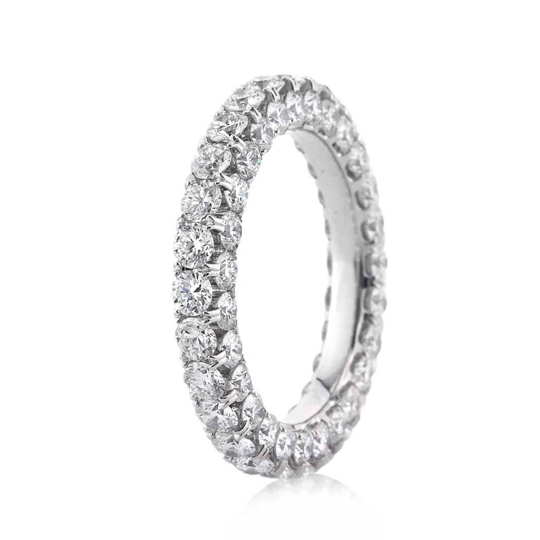 This stunning diamond eternity band features 4.00ct of round brilliant cut diamonds micro pavé set on all three sides for intense sparkle. They are set in 18k white gold and graded at E-F in color, VS1-VS2 in clarity. All eternity bands are shown in